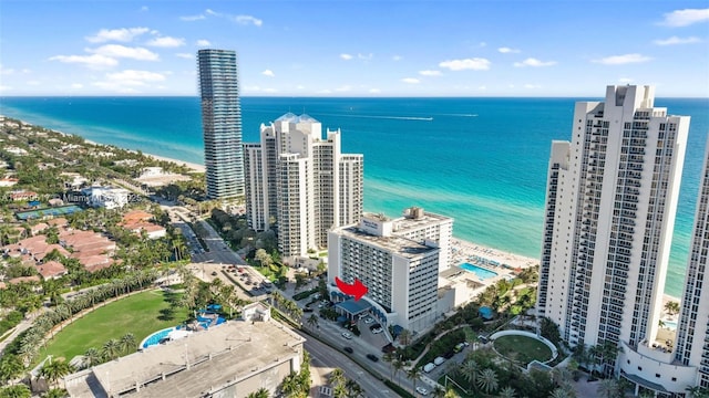 bird's eye view with a water view and a beach view