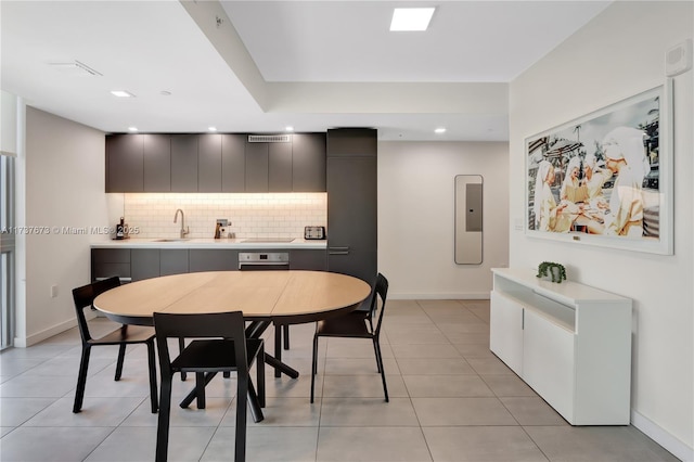 tiled dining space featuring sink