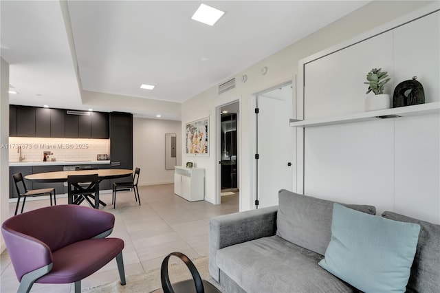 living room featuring electric panel and light tile patterned floors