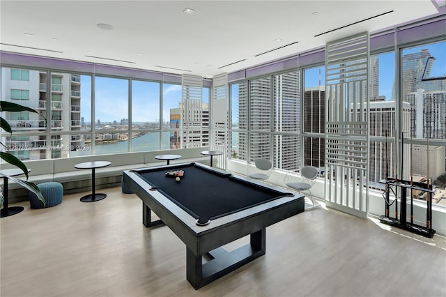 playroom with a water view, pool table, and light wood-type flooring