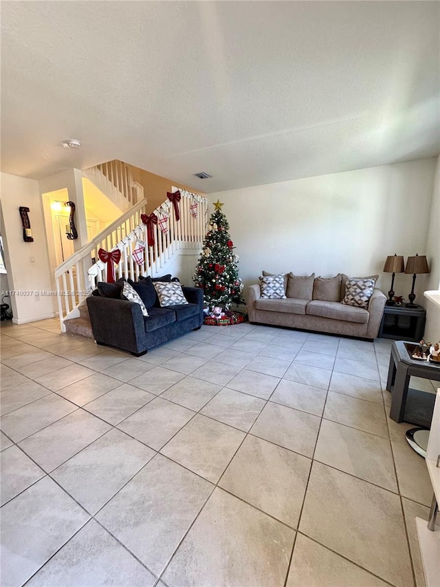 living room with light tile patterned floors and a textured ceiling