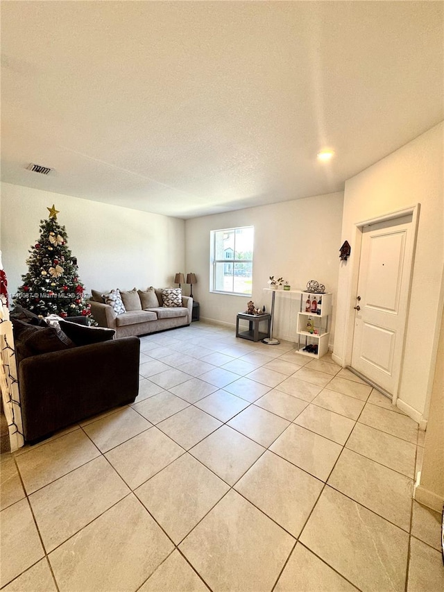 living room with light tile patterned flooring and a textured ceiling