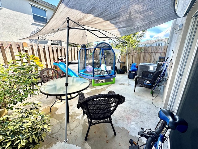 view of patio / terrace featuring a trampoline and central air condition unit