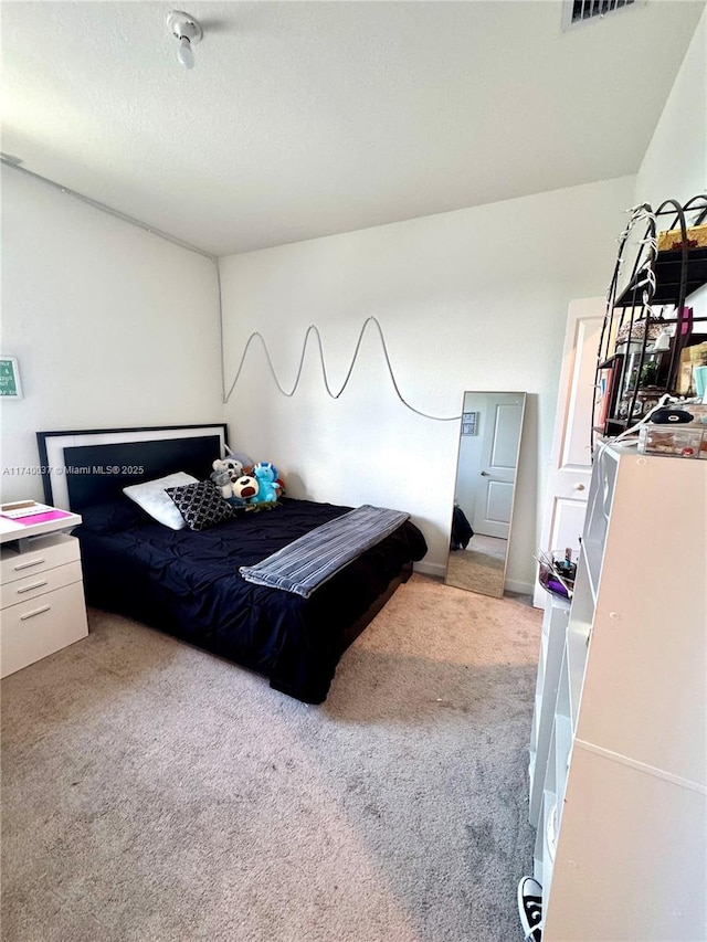 carpeted bedroom featuring a textured ceiling