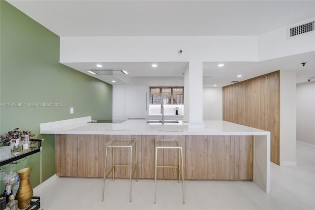 kitchen featuring kitchen peninsula and sink