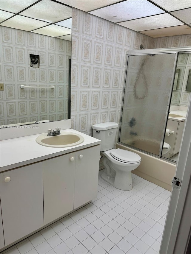 full bathroom featuring tile patterned flooring, enclosed tub / shower combo, vanity, and toilet