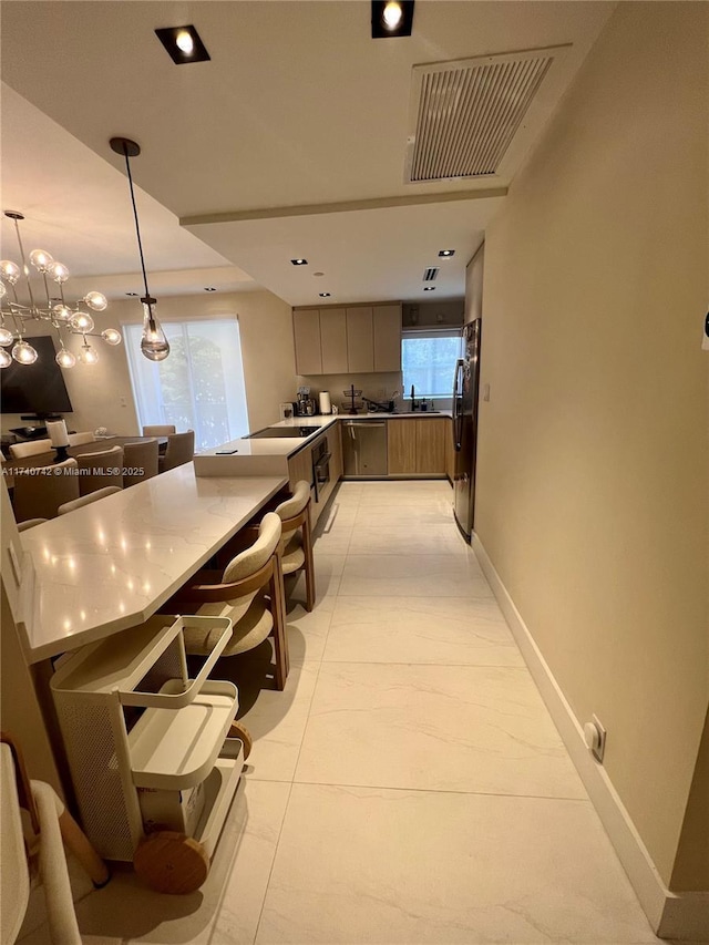 kitchen featuring light tile patterned flooring, a breakfast bar, hanging light fixtures, fridge, and kitchen peninsula