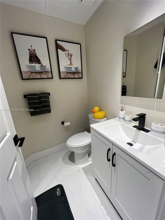 bathroom featuring vanity and toilet