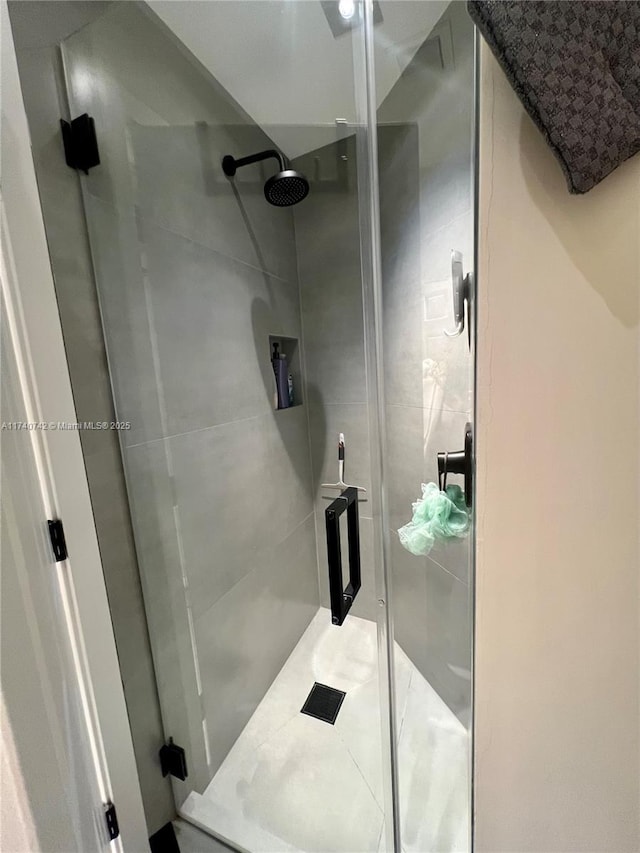 bathroom with a shower with door