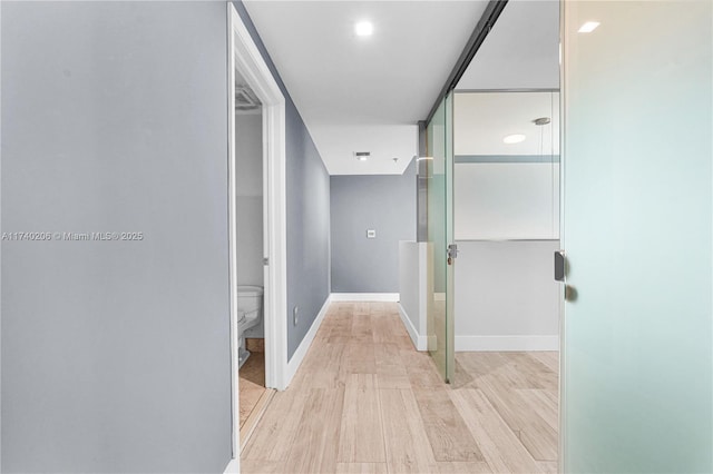 corridor with light hardwood / wood-style flooring