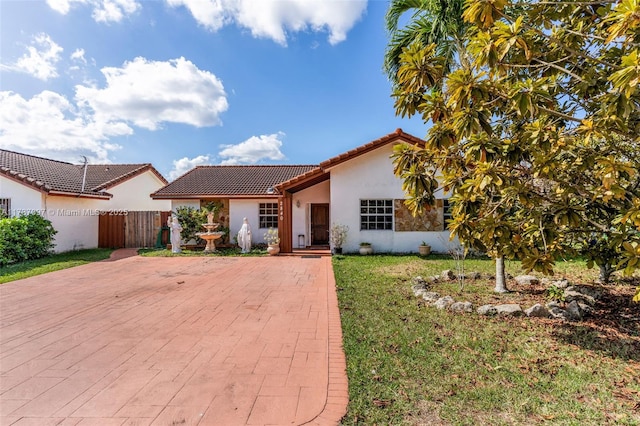 mediterranean / spanish-style house with a front lawn