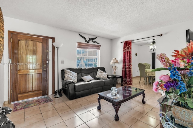 living room featuring light tile patterned flooring and a textured ceiling