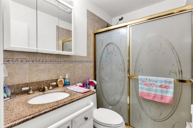 bathroom with tile walls, decorative backsplash, vanity, walk in shower, and toilet