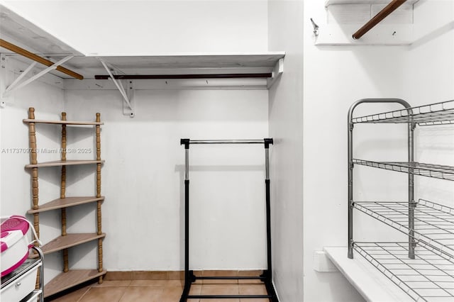 walk in closet with tile patterned floors