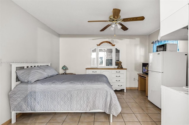 bedroom featuring light tile patterned flooring, ceiling fan, and white fridge