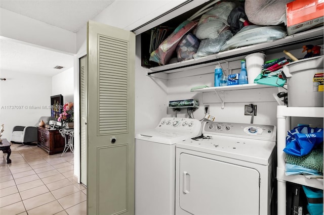 laundry room with light tile patterned flooring and independent washer and dryer