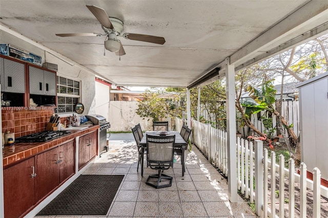 view of patio with ceiling fan, sink, and area for grilling