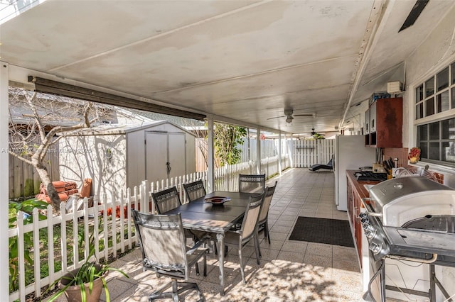 view of patio / terrace featuring ceiling fan and a storage unit