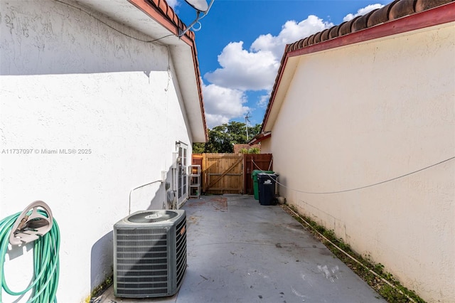 view of property exterior with a patio area and central air condition unit