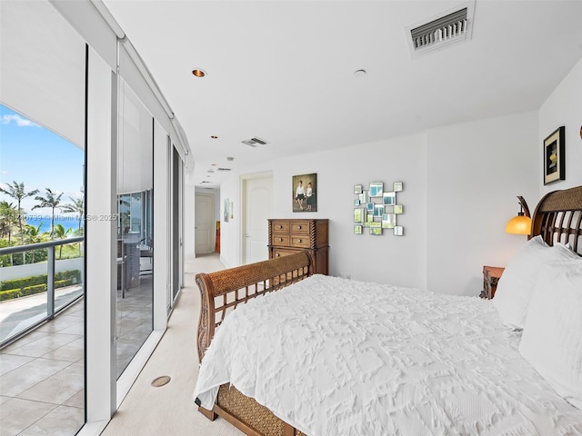 bedroom featuring expansive windows and access to outside