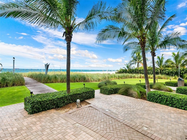 view of community with a water view and a lawn