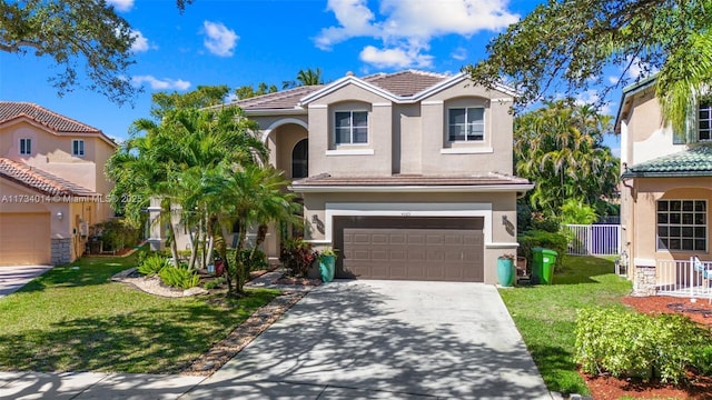 mediterranean / spanish-style home with a garage and a front lawn