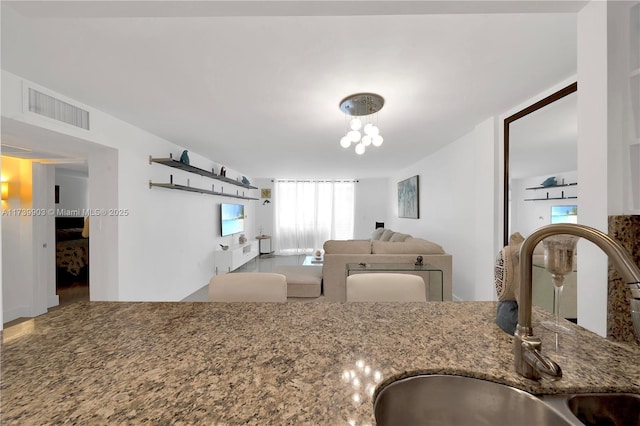 kitchen with stone counters and sink