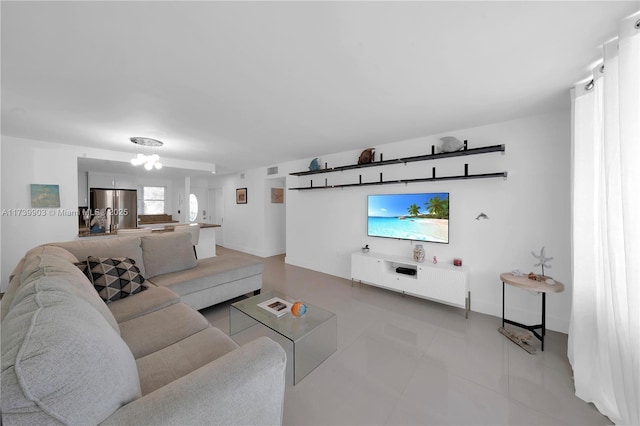 3750 NE 170th St Unit 101, North Miami Beach, FL 33160 - living area featuring baseboards, light tile patterned flooring, and a chandelier