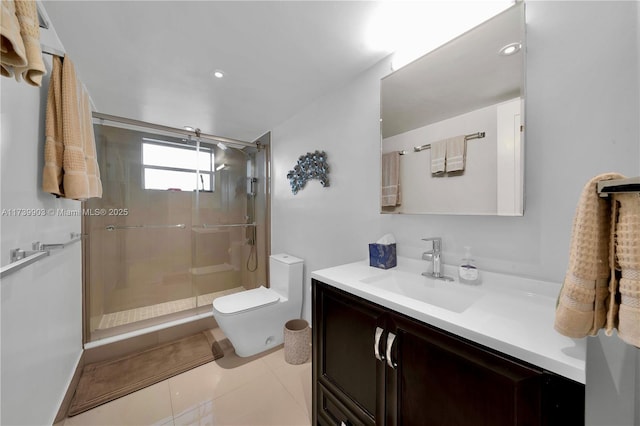 bathroom with vanity, a shower with shower door, tile patterned floors, and toilet