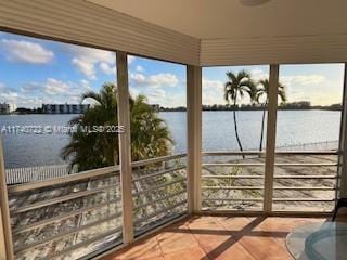 sunroom / solarium with a water view