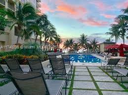 pool at dusk featuring a patio area