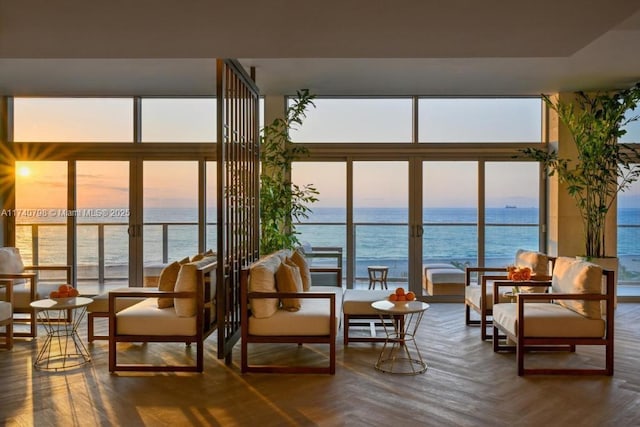 sunroom featuring a water view