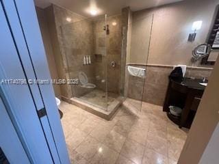 bathroom with vanity, a shower with shower door, and toilet