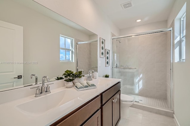 bathroom with walk in shower, vanity, toilet, and tile patterned flooring