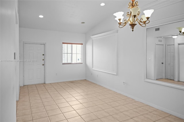 spare room with lofted ceiling and a chandelier