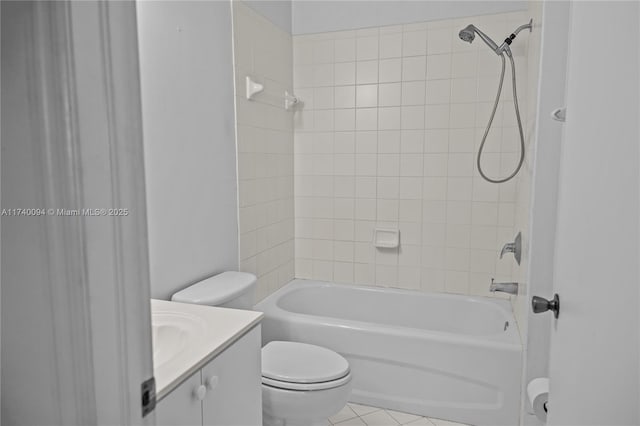 full bathroom featuring vanity, tile patterned flooring, tiled shower / bath combo, and toilet