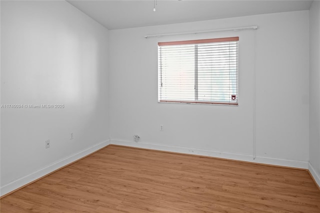 unfurnished room with light wood-type flooring