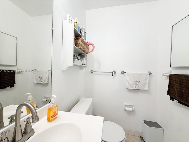 bathroom with tile patterned flooring, sink, and toilet