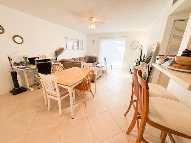 dining space featuring light tile patterned floors and ceiling fan