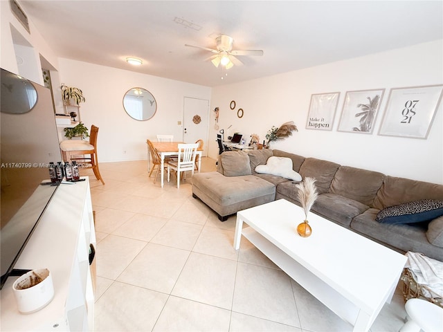 living room featuring light tile patterned flooring and ceiling fan