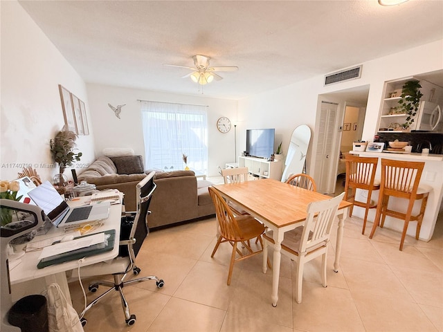 dining area featuring ceiling fan and light tile patterned floors