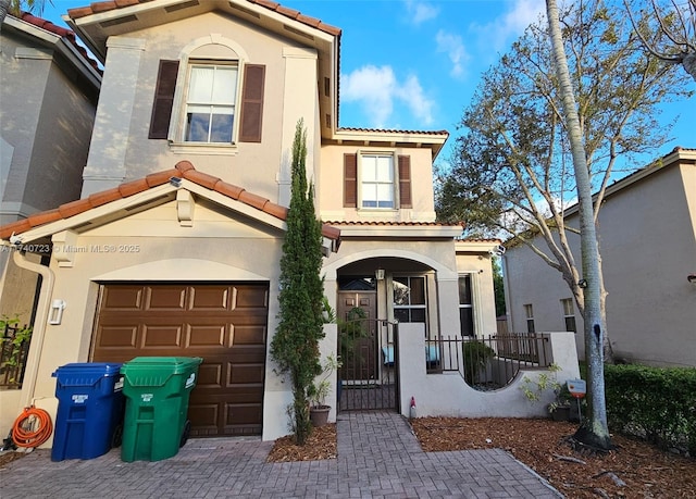 mediterranean / spanish-style house with a garage