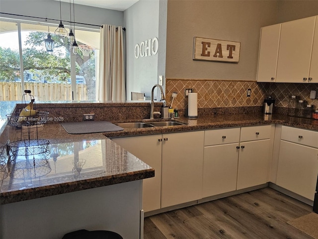 kitchen with tasteful backsplash, sink, dark hardwood / wood-style flooring, and white cabinets