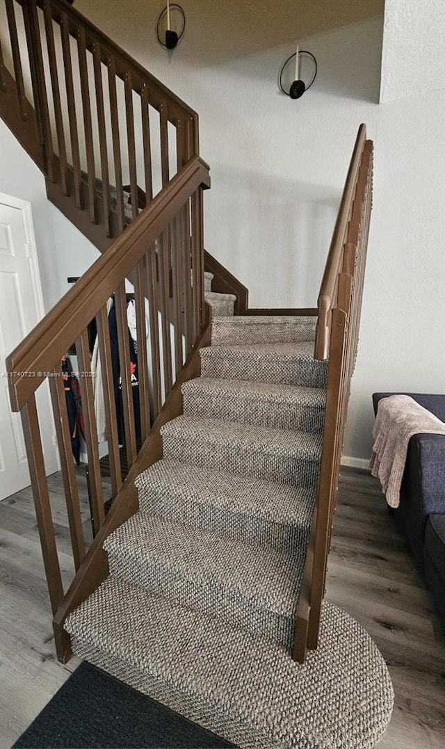 staircase with hardwood / wood-style floors