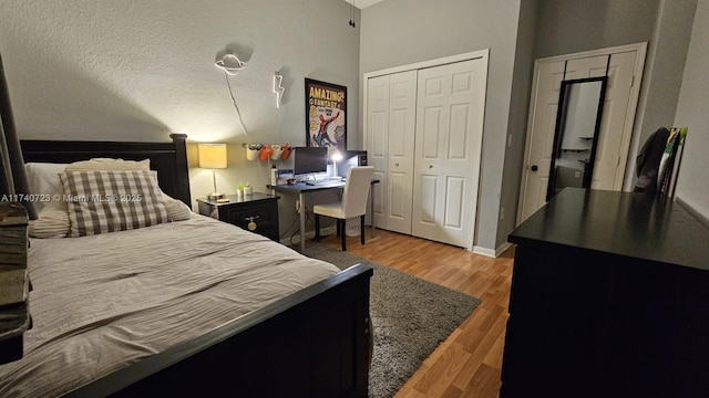 bedroom with hardwood / wood-style floors and a closet