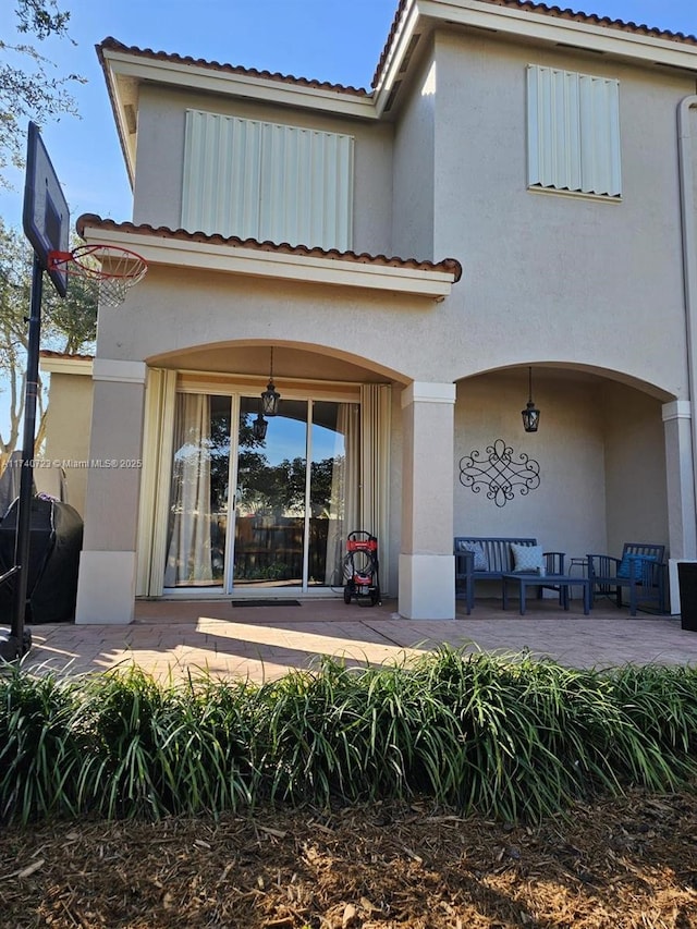 rear view of house featuring a patio