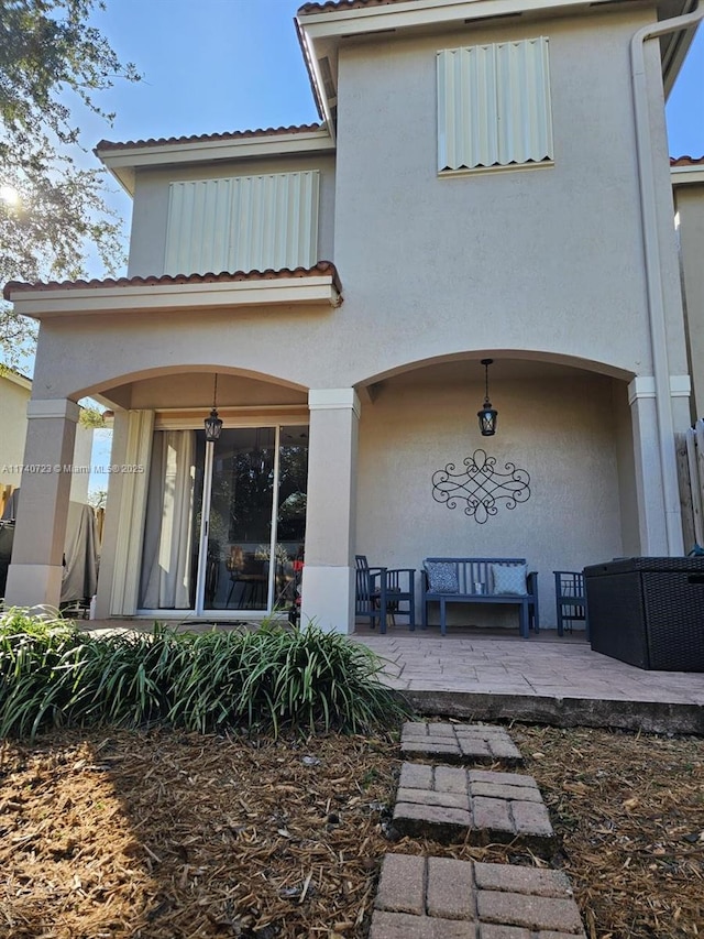 rear view of property featuring a patio