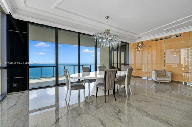 dining space with floor to ceiling windows, a water view, ornamental molding, a tray ceiling, and a notable chandelier