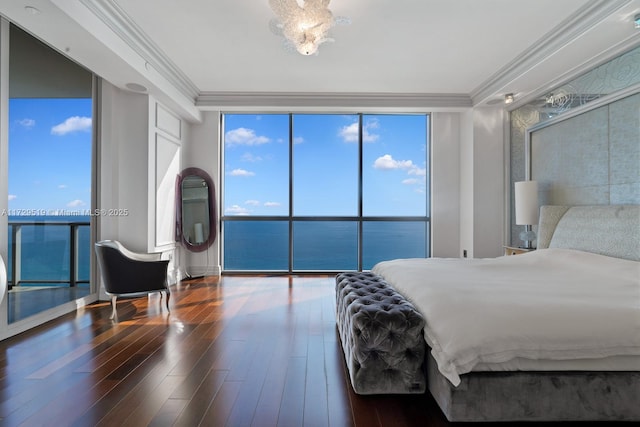 bedroom with hardwood / wood-style flooring, a wall of windows, multiple windows, a water view, and ornamental molding