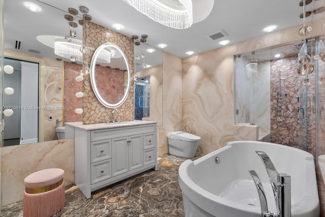 bathroom featuring vanity, toilet, and a tub to relax in